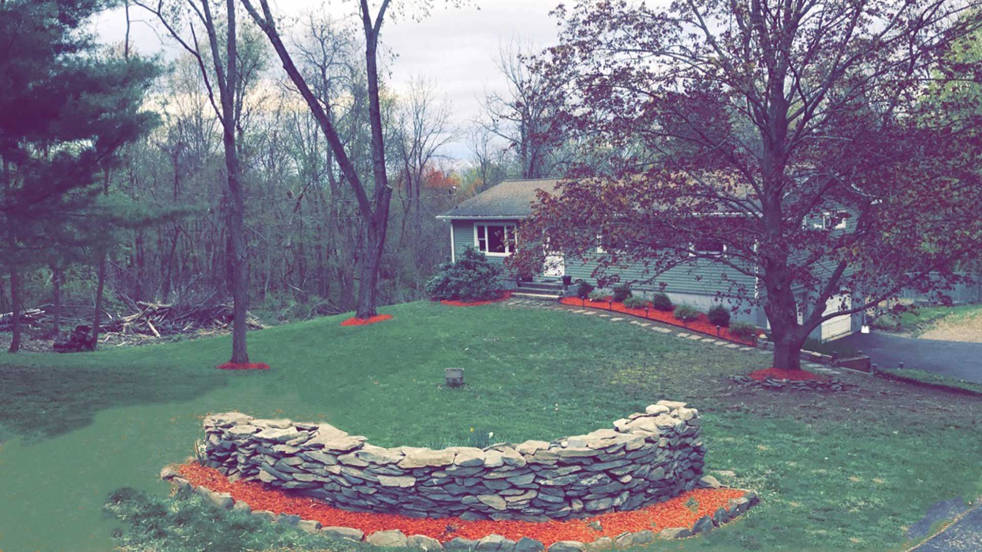 New landscaping installed by our team that includes red mulch.