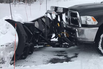Close up photo of our plow attached to our work truck.